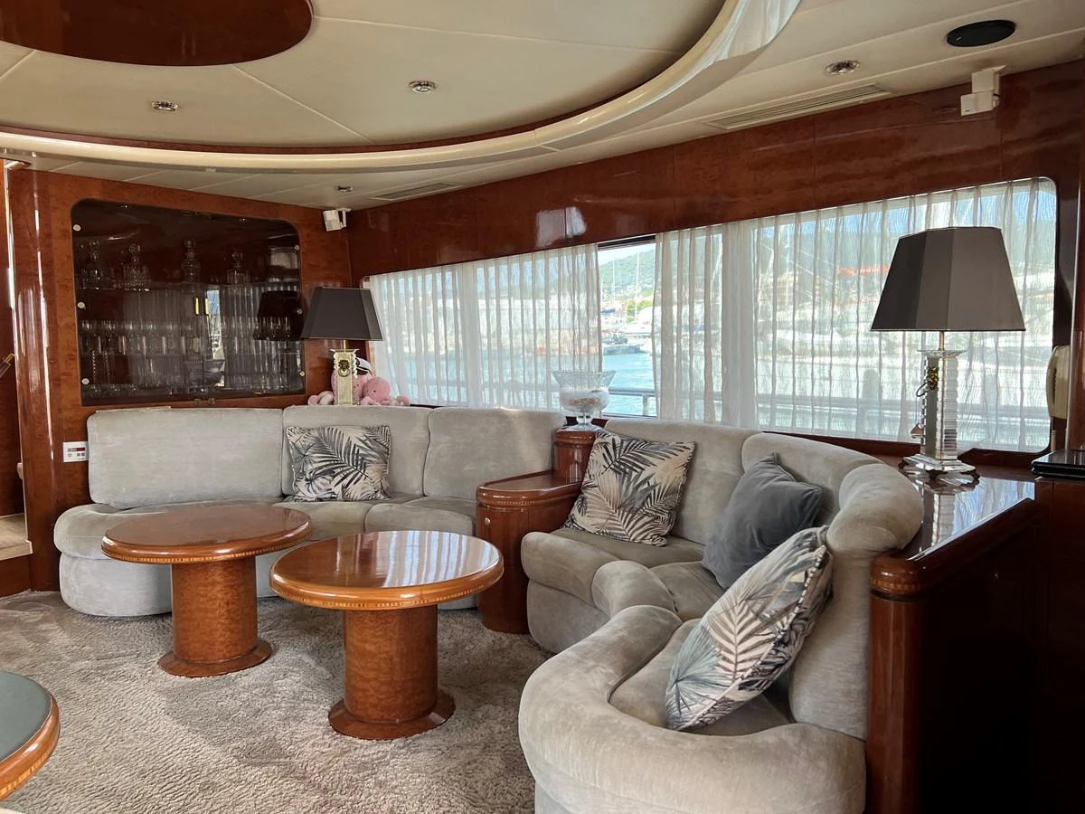 The salon features plush seating, wooden accents, and large windows for a comfortable and elegant atmosphere. aboard HORIZON ELEGANCE 82 S Yacht for Sale