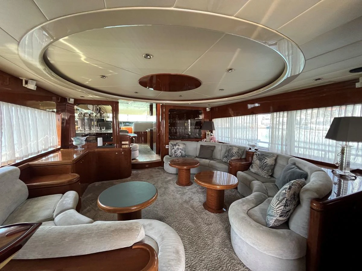 The salon features plush seating and elegant wooden accents, creating a luxurious and inviting atmosphere. aboard HORIZON ELEGANCE 82 S Yacht for Sale