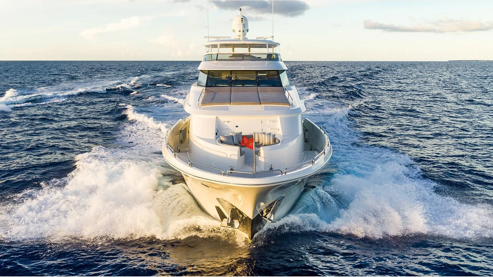 A luxurious yacht cuts through the water, showcasing its sleek design and powerful presence. aboard KEMOSABE Yacht for Sale