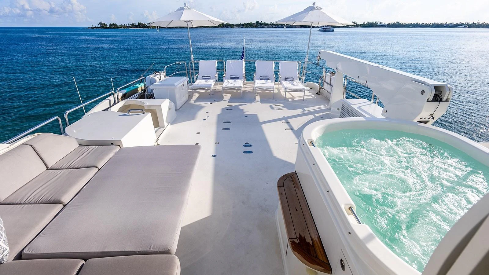 The sundeck features a luxurious hot tub and ample lounging space with stunning ocean views. aboard KEMOSABE Yacht for Sale