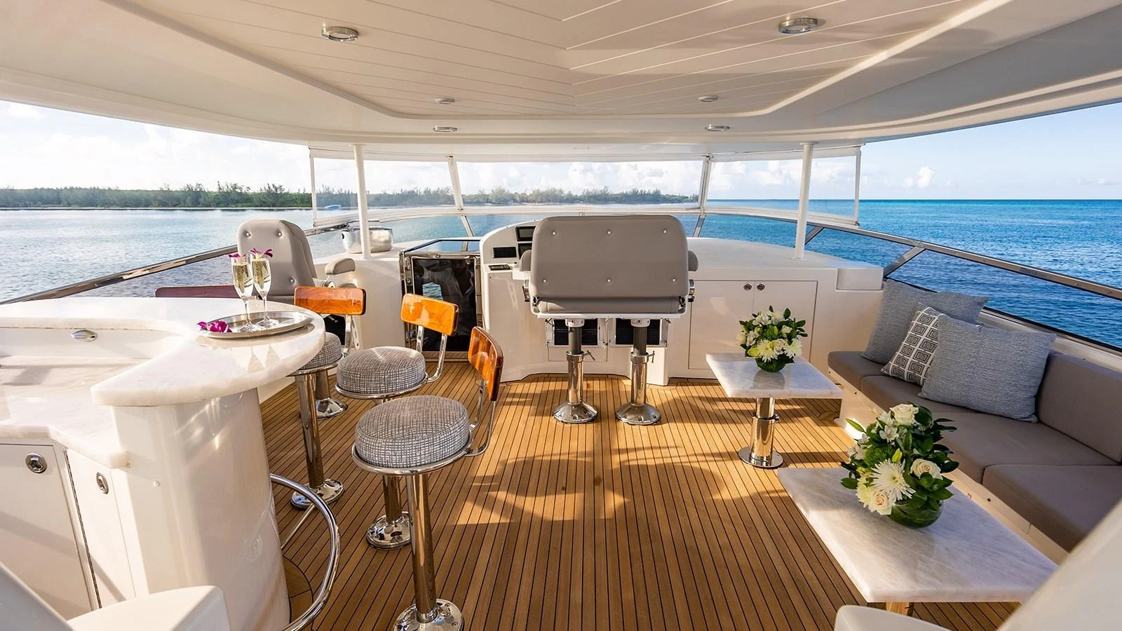 The flybridge offers a spacious and luxurious area with comfortable seating and stunning ocean views. aboard KEMOSABE Yacht for Sale