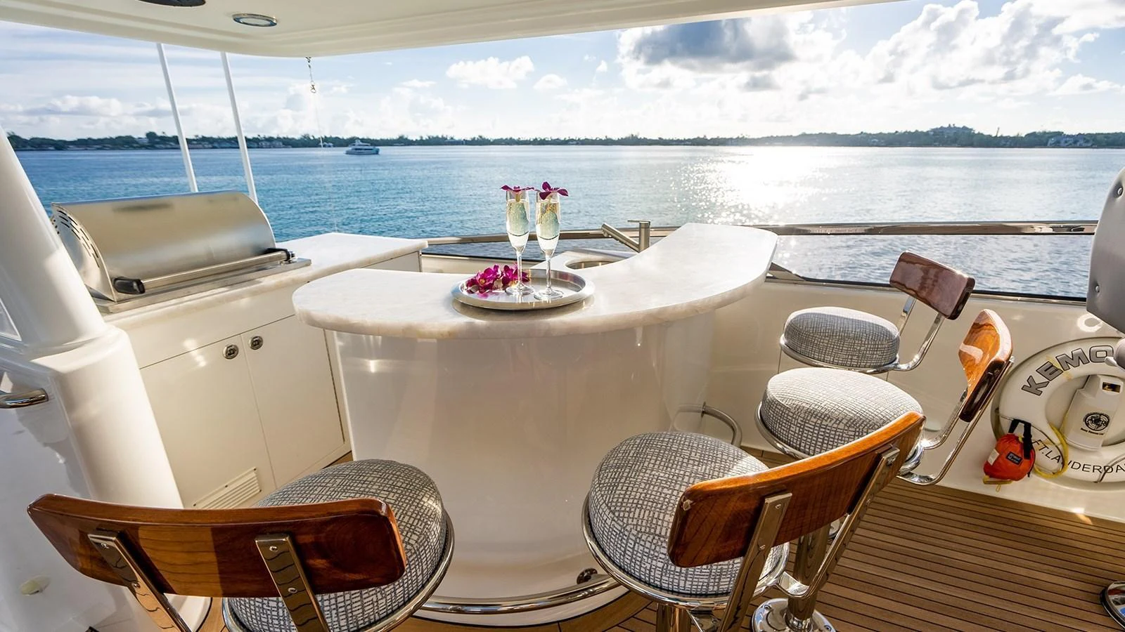 The yacht features a stylish bar area with a beautiful ocean view, perfect for relaxing and socializing. aboard KEMOSABE Yacht for Sale