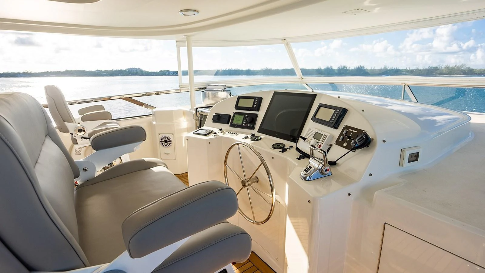 The helm station offers a commanding view with state-of-the-art navigation equipment and luxurious seating. aboard KEMOSABE Yacht for Sale