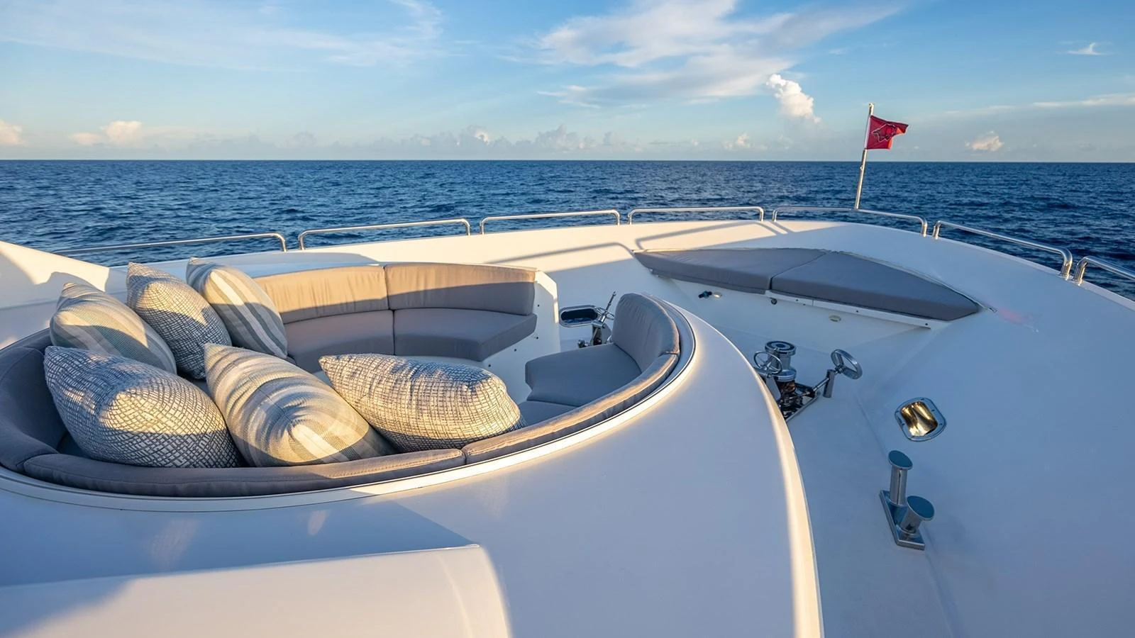 The foredeck features a luxurious seating area with plush cushions, perfect for relaxation while enjoying the ocean view. aboard KEMOSABE Yacht for Sale