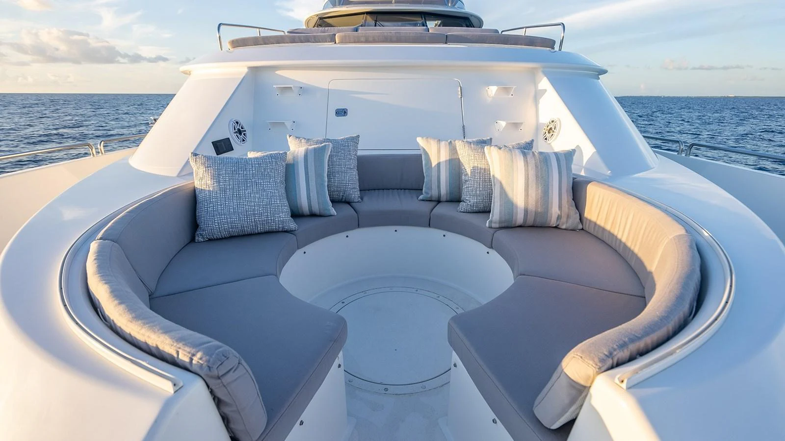 The yacht features a luxurious bow lounge with plush seating and scenic ocean views. aboard KEMOSABE Yacht for Sale