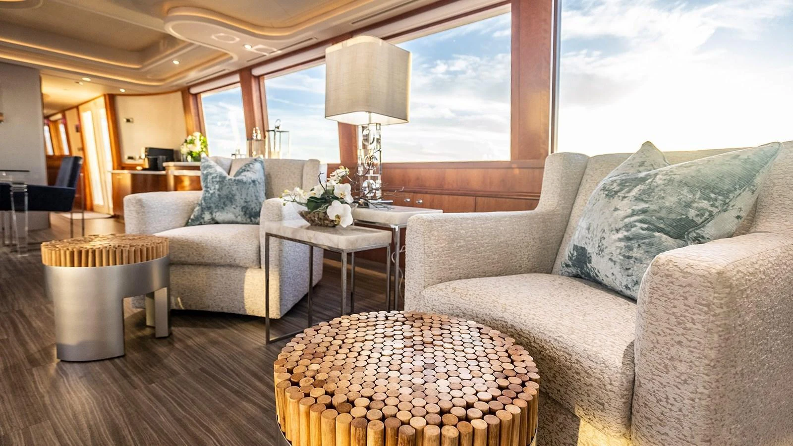 The salon features plush seating with a contemporary design and large windows offering stunning views. aboard KEMOSABE Yacht for Sale