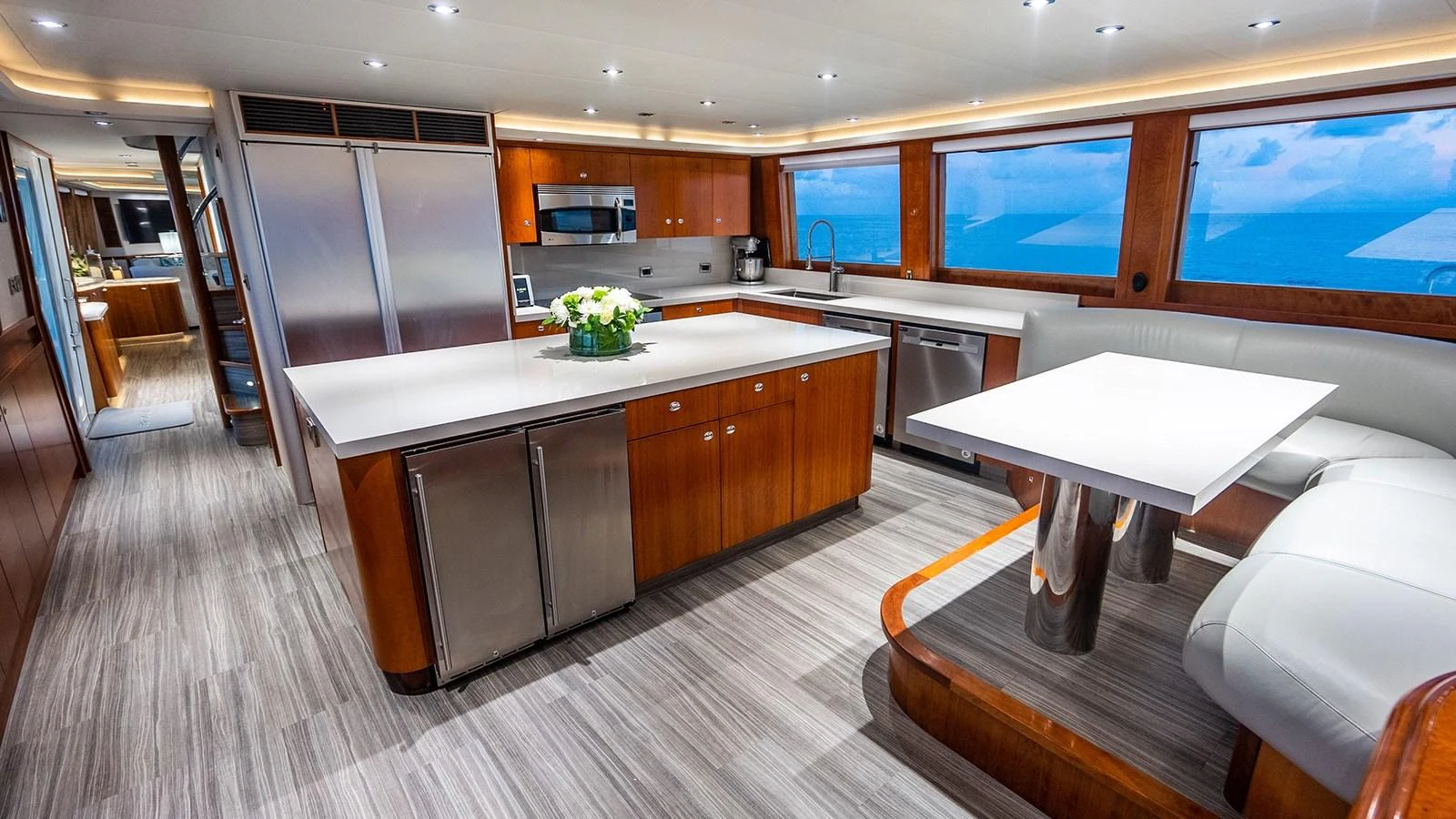 The yacht's galley features modern appliances, ample counter space, and a cozy dining area with panoramic windows. aboard KEMOSABE Yacht for Sale