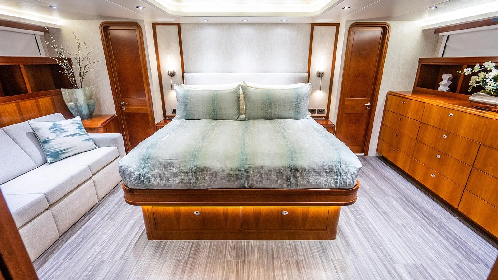 The master stateroom features a luxurious bed with elegant wooden furnishings and ample storage space. aboard KEMOSABE Yacht for Sale