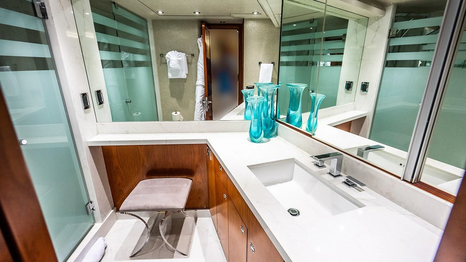 The bathroom features a modern design with a sleek countertop and ample storage space. aboard KEMOSABE Yacht for Sale