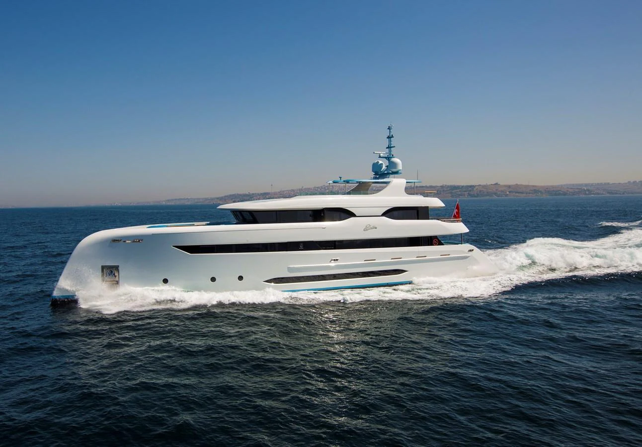 A sleek and modern yacht glides effortlessly across the open sea on a clear day. aboard ELADA Yacht for Sale