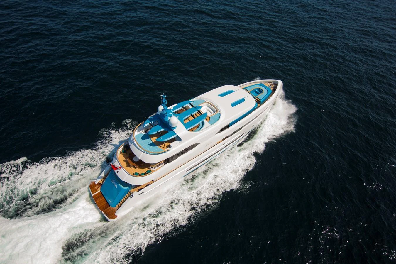 A sleek and modern yacht cruises through the open sea, showcasing its elegant design and luxurious amenities. aboard ELADA Yacht for Sale