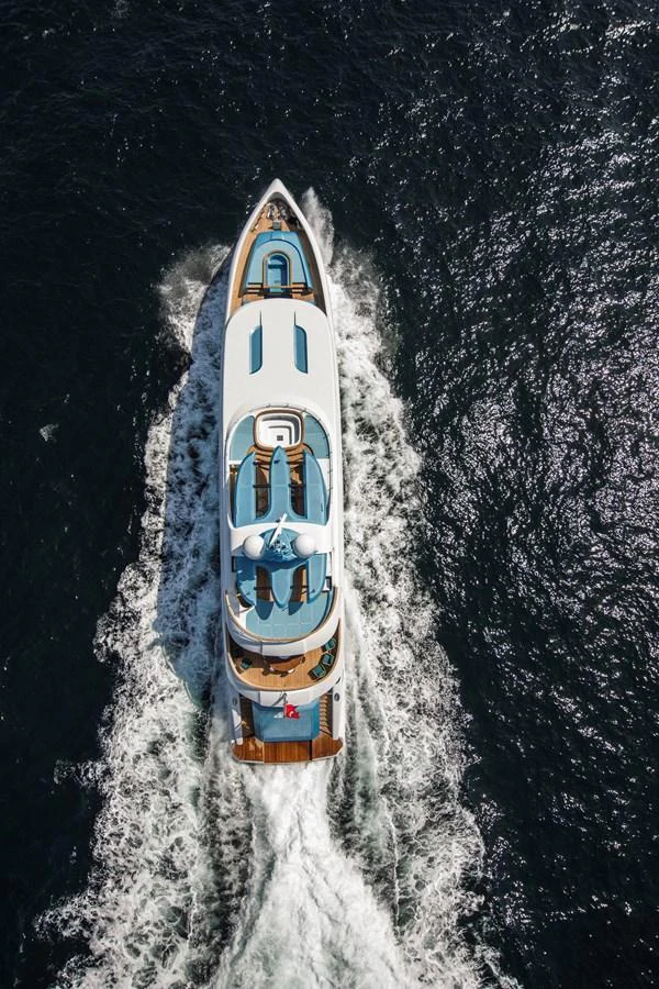 An aerial view of a luxurious yacht cruising through the water, showcasing its sleek design and spacious decks. aboard ELADA Yacht for Sale