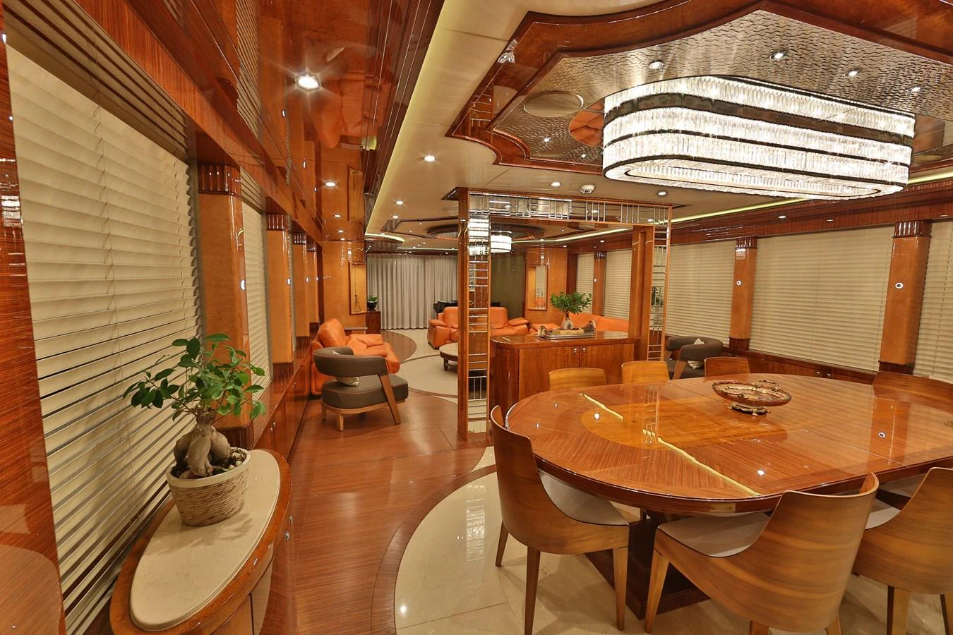 The yacht's dining area features luxurious wooden finishes and elegant lighting. aboard ELADA Yacht for Sale