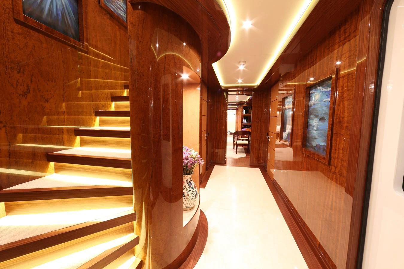 The yacht's interior hallway features luxurious wood paneling and elegant lighting. aboard ELADA Yacht for Sale