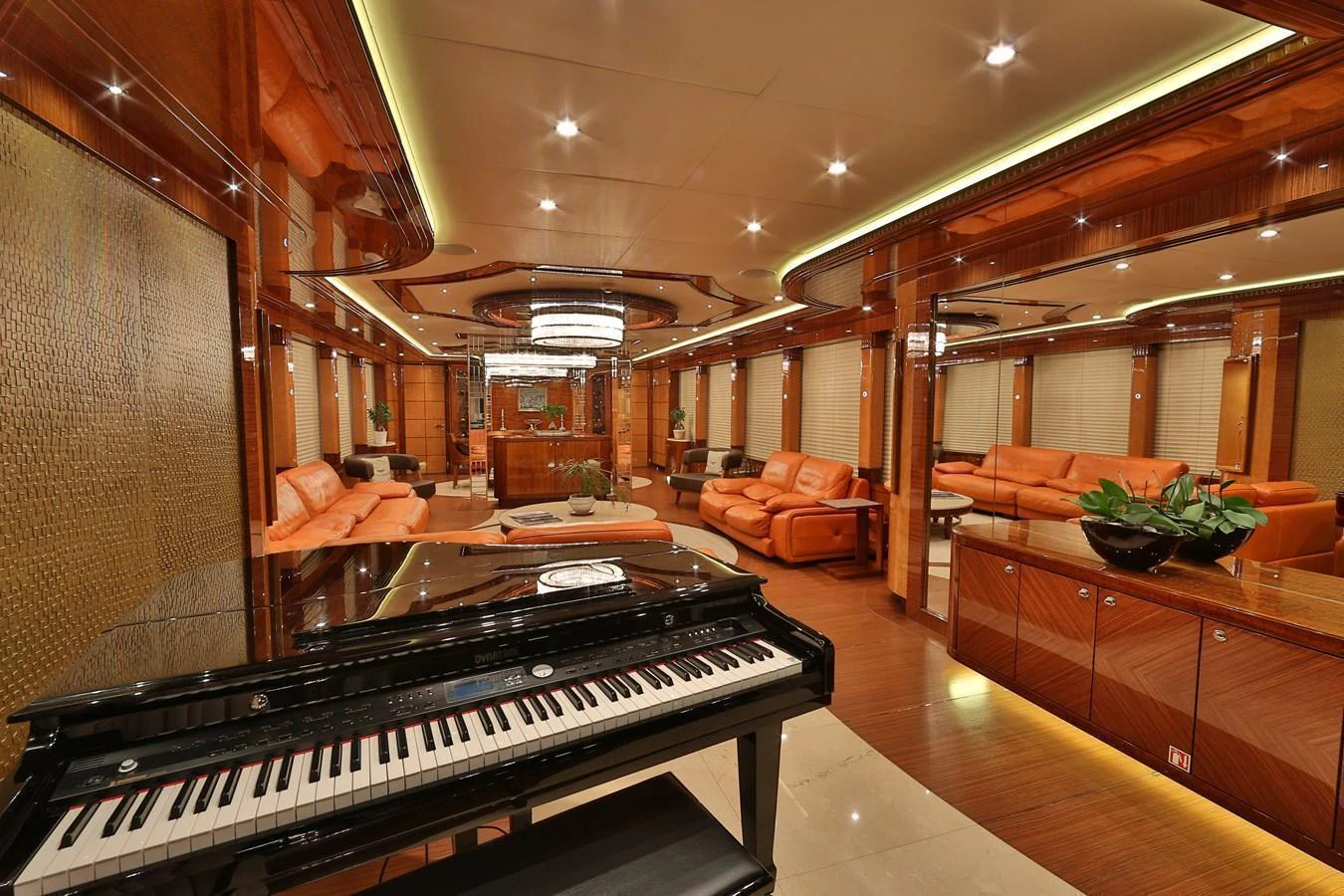 The luxurious interior features elegant wood finishes, plush seating, and a grand piano, creating a sophisticated ambiance. aboard ELADA Yacht for Sale