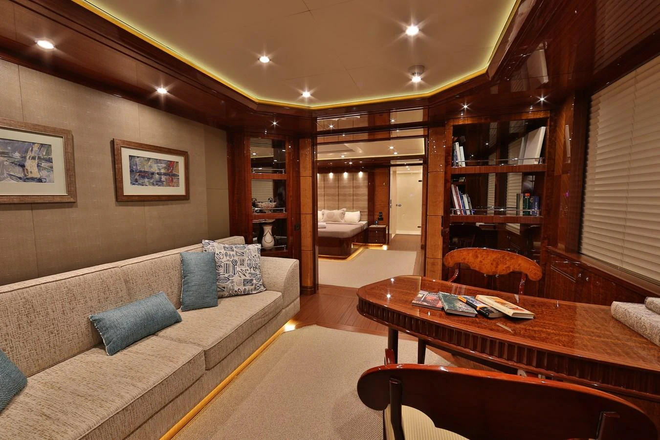 The yacht's salon features elegant wood finishes, comfortable seating, and tasteful decor. aboard ELADA Yacht for Sale