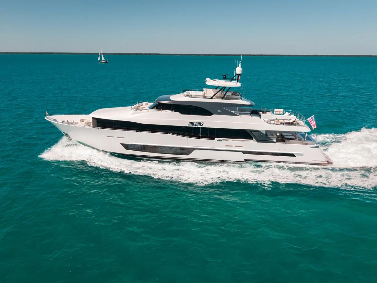 A sleek, modern yacht cruises through clear blue waters under a bright sky. aboard OCEAN ALEXANDER 37L/01 Yacht for Sale