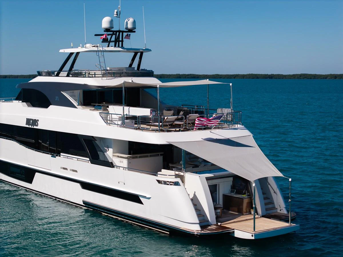 The yacht's sleek exterior features a spacious aft deck with a retractable sunshade, perfect for relaxing by the water. aboard OCEAN ALEXANDER 37L/01 Yacht for Sale