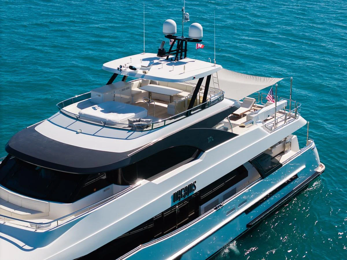 A luxurious yacht cruising on clear blue waters, showcasing its elegant flybridge and sleek design. aboard OCEAN ALEXANDER 37L/01 Yacht for Sale