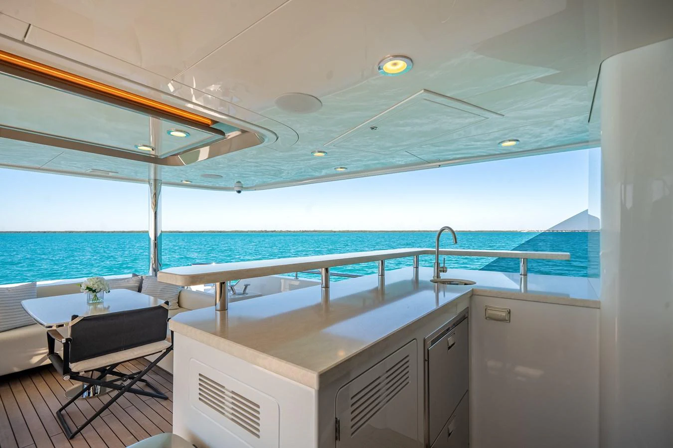 The aft deck features a sleek bar area with a stunning ocean view. aboard OCEAN ALEXANDER 37L/01 Yacht for Sale