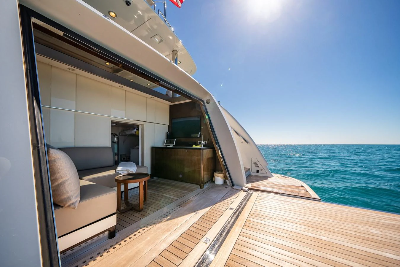The aft deck offers a seamless transition from indoor to outdoor living with a spacious lounging area and stunning ocean views. aboard OCEAN ALEXANDER 37L/01 Yacht for Sale
