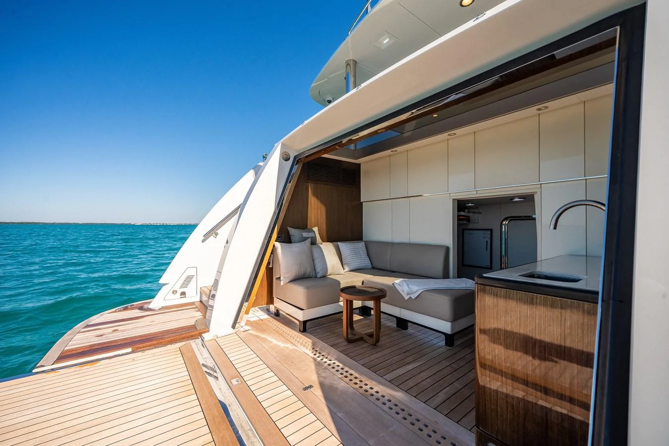 The aft deck features a cozy seating area with a small table, perfect for relaxation and enjoying the view. aboard OCEAN ALEXANDER 37L/01 Yacht for Sale