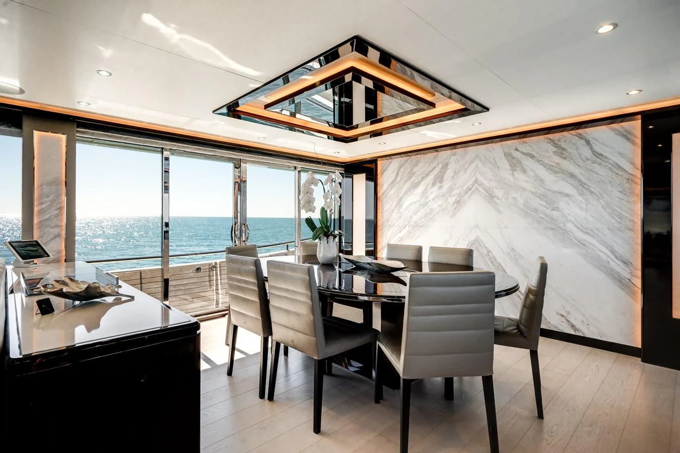 The yacht's dining area features a sleek, modern design with panoramic ocean views. aboard OCEAN ALEXANDER 37L/01 Yacht for Sale