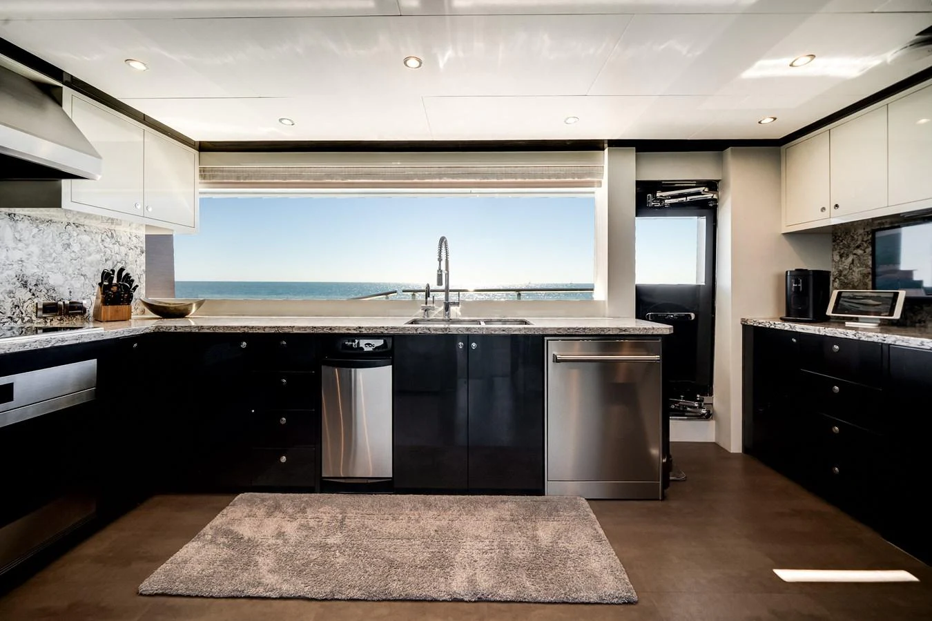 The galley features modern appliances and a stunning ocean view through a large window. aboard OCEAN ALEXANDER 37L/01 Yacht for Sale