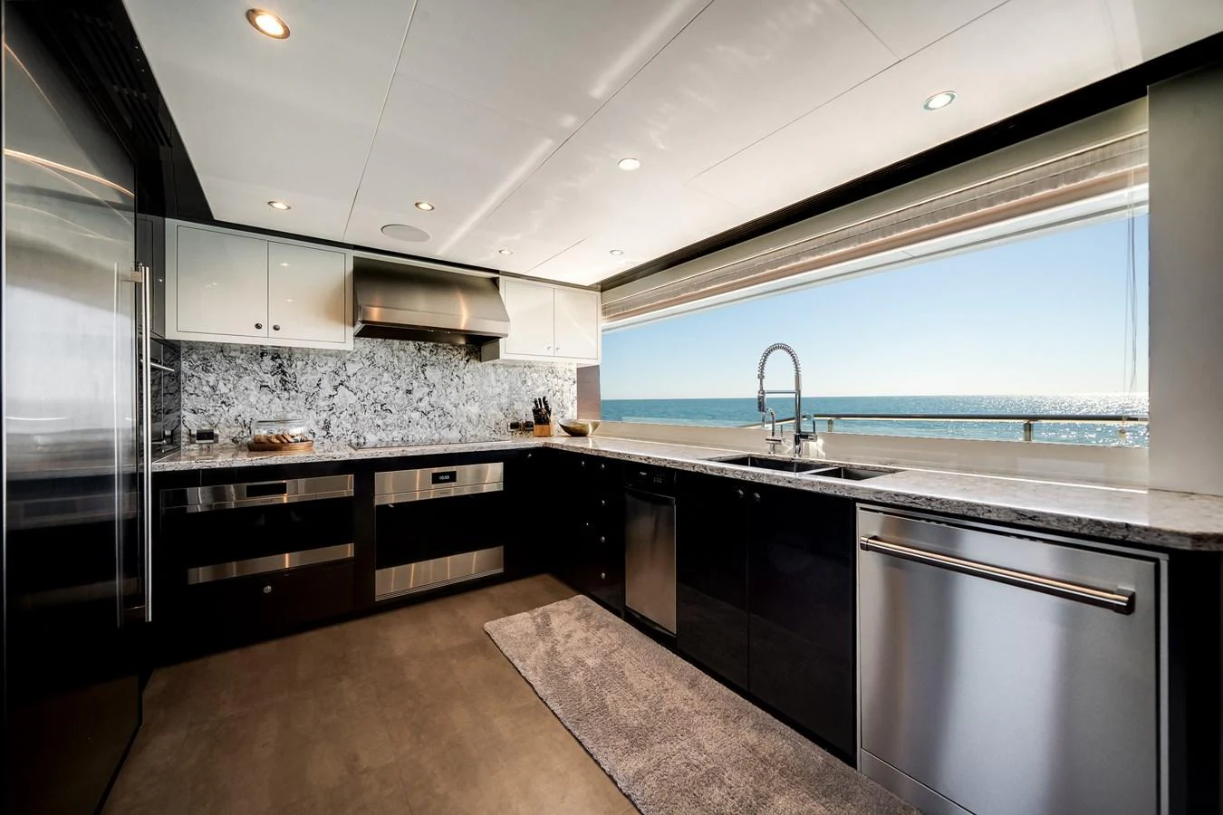 The galley features modern appliances and a stunning ocean view through a large window. aboard OCEAN ALEXANDER 37L/01 Yacht for Sale