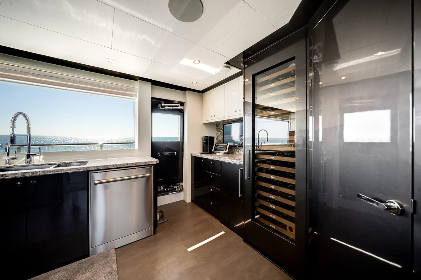The galley features modern appliances and sleek cabinetry with a stunning ocean view. aboard OCEAN ALEXANDER 37L/01 Yacht for Sale
