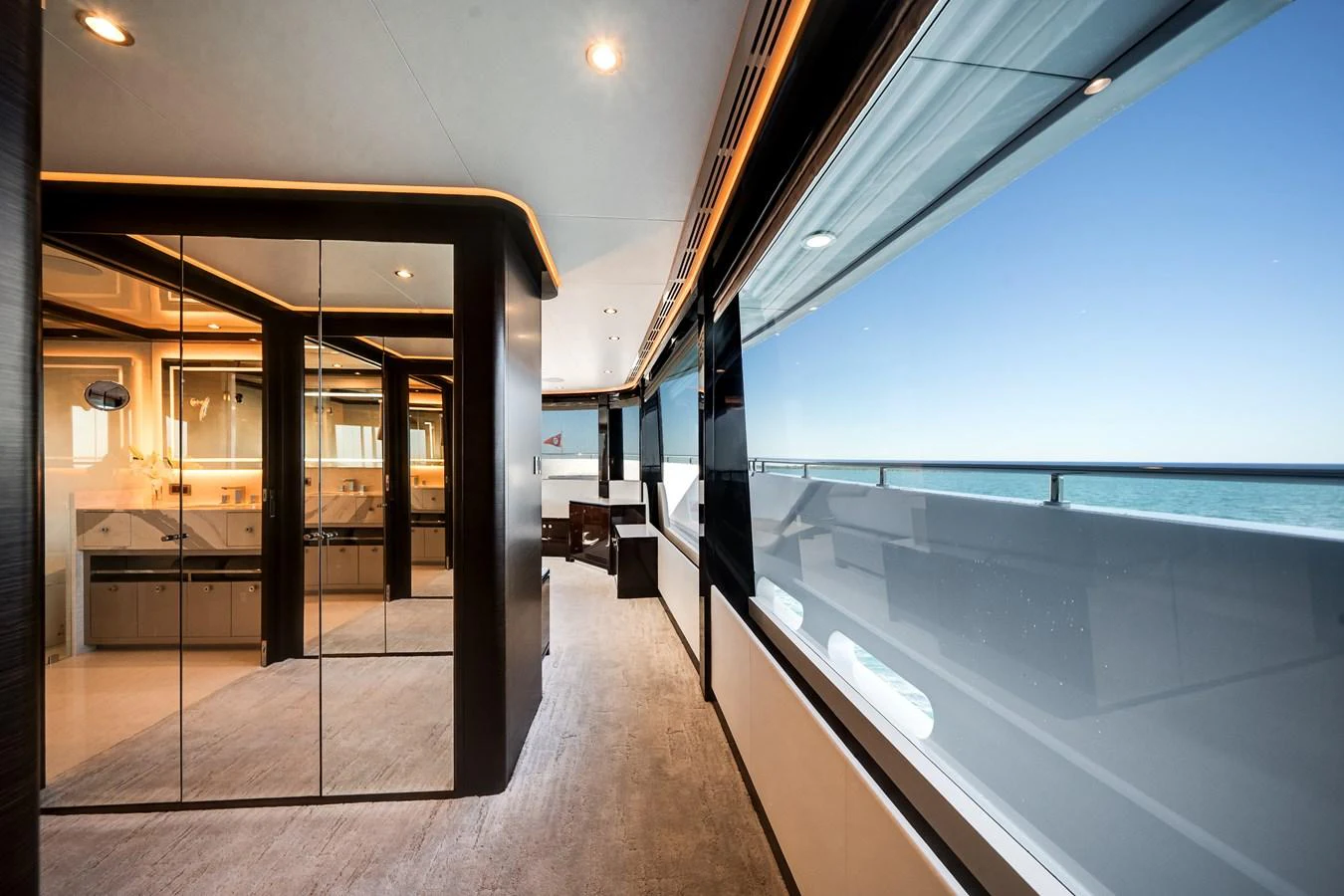 The yacht's interior features a spacious hallway with large windows offering stunning ocean views. aboard OCEAN ALEXANDER 37L/01 Yacht for Sale