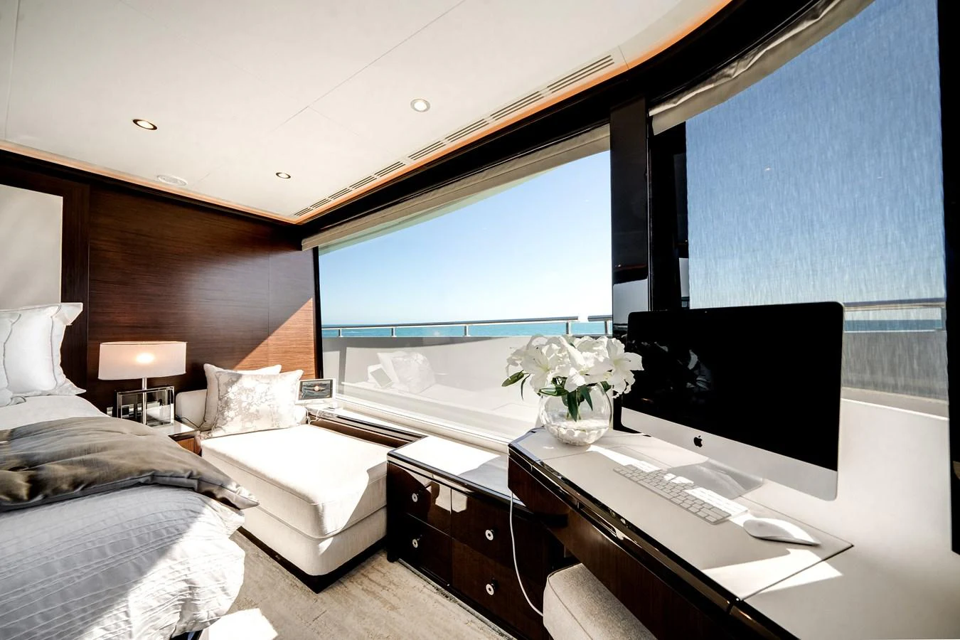 A luxurious stateroom with a large window offering a stunning ocean view. aboard OCEAN ALEXANDER 37L/01 Yacht for Sale