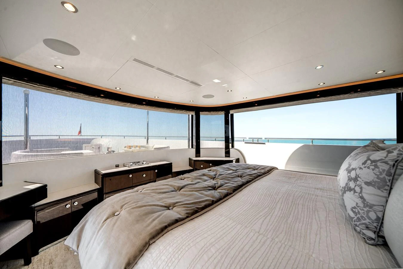The master stateroom offers panoramic views and luxurious comfort with its expansive windows and elegant bedding. aboard OCEAN ALEXANDER 37L/01 Yacht for Sale