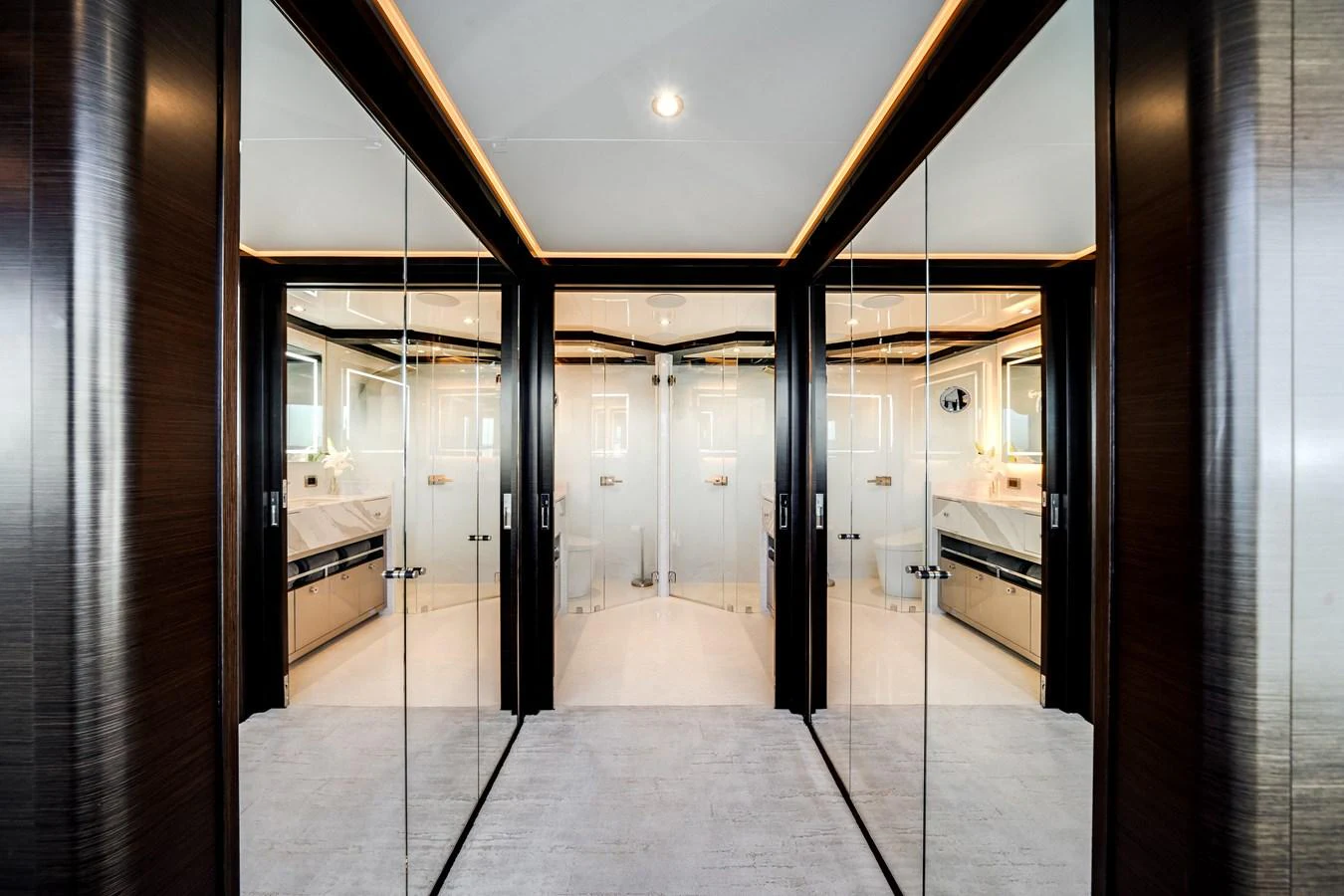 The yacht's interior features a luxurious, mirrored hallway leading to an elegant bathroom. aboard OCEAN ALEXANDER 37L/01 Yacht for Sale