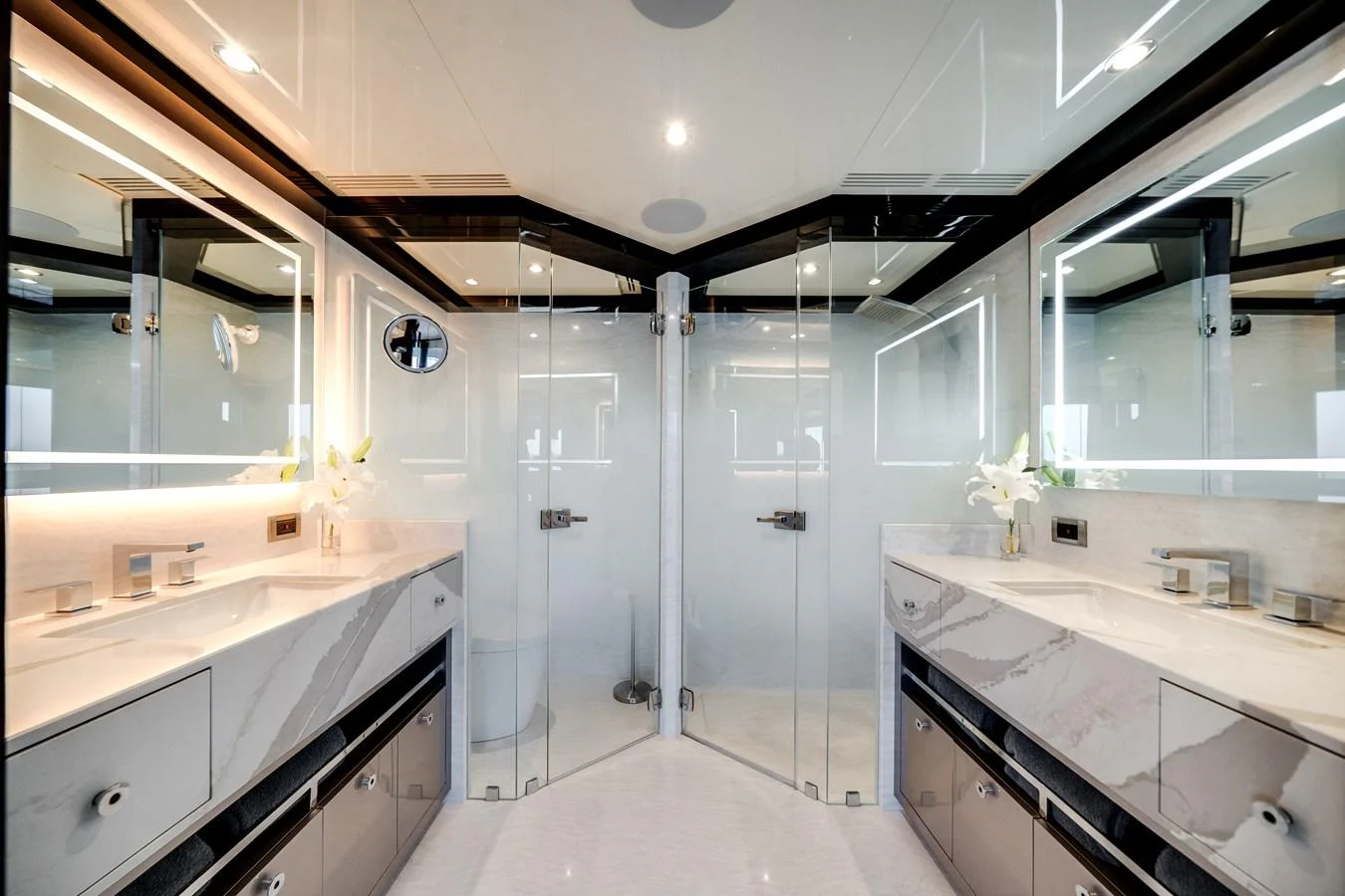 A luxurious yacht bathroom featuring dual sinks and a spacious glass-enclosed shower. aboard OCEAN ALEXANDER 37L/01 Yacht for Sale