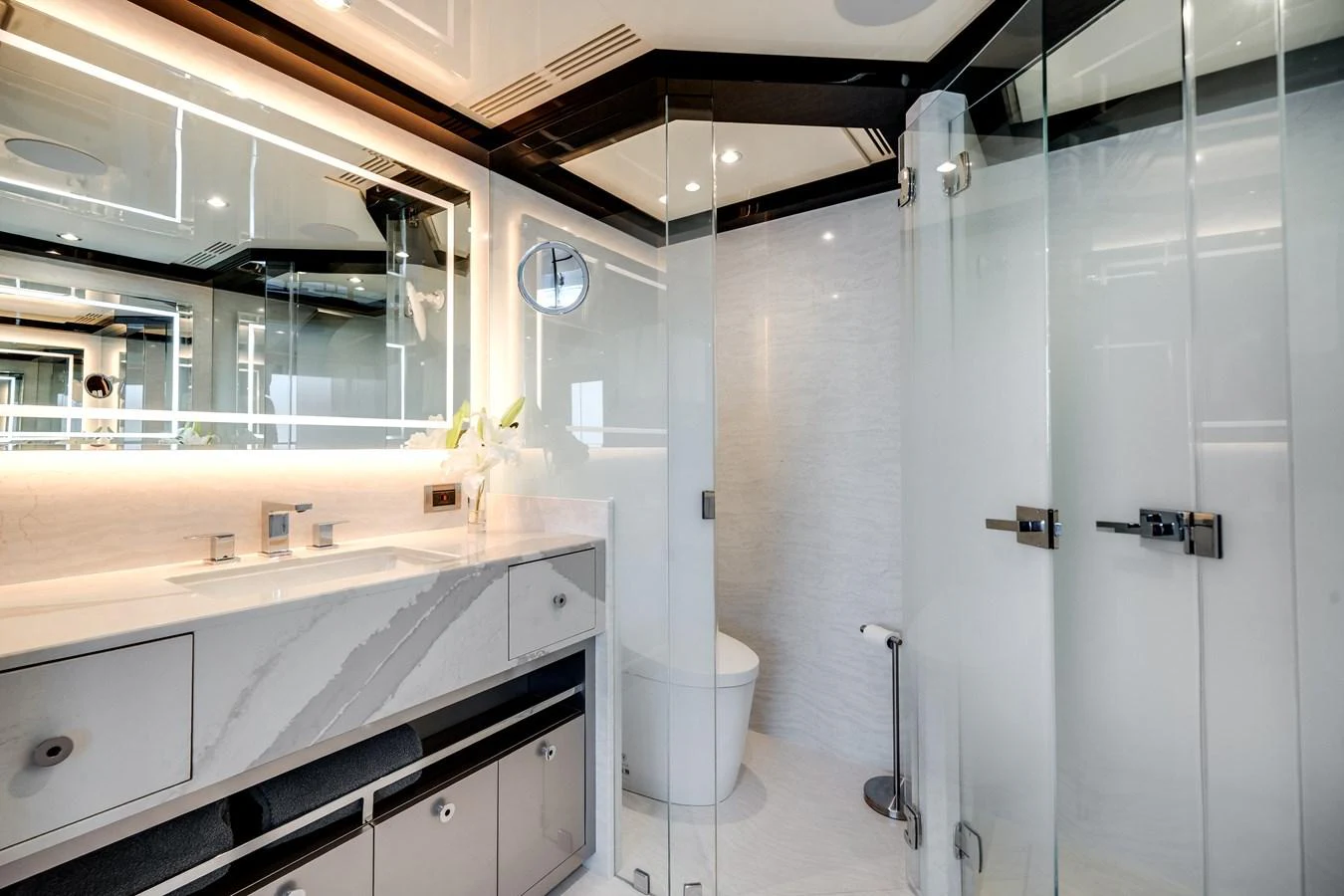 The yacht's bathroom features a sleek, modern design with glass shower doors and elegant fixtures. aboard OCEAN ALEXANDER 37L/01 Yacht for Sale