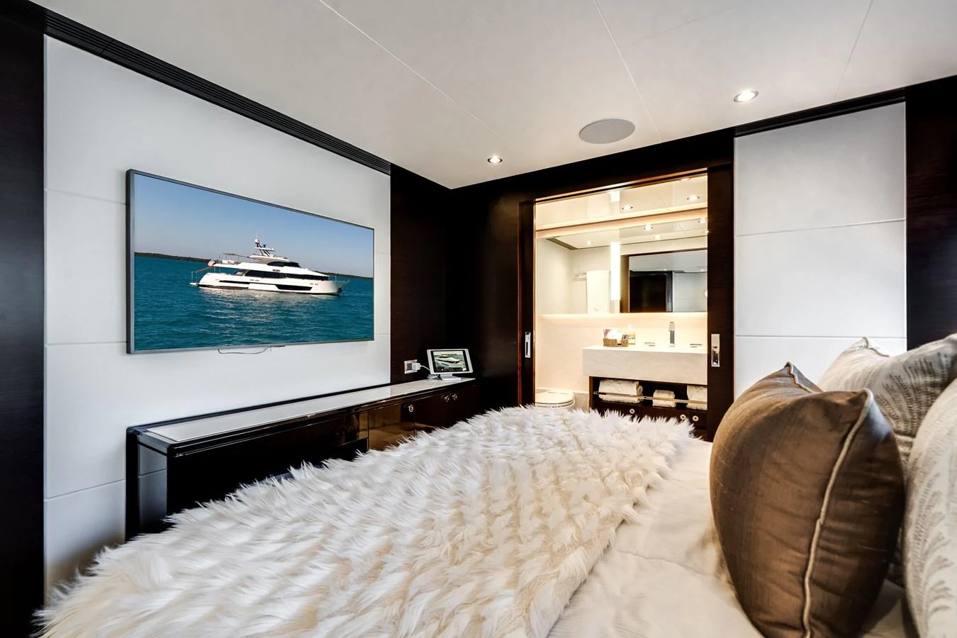 A luxurious stateroom featuring a plush bed, modern decor, and an ensuite bathroom. aboard OCEAN ALEXANDER 37L/01 Yacht for Sale