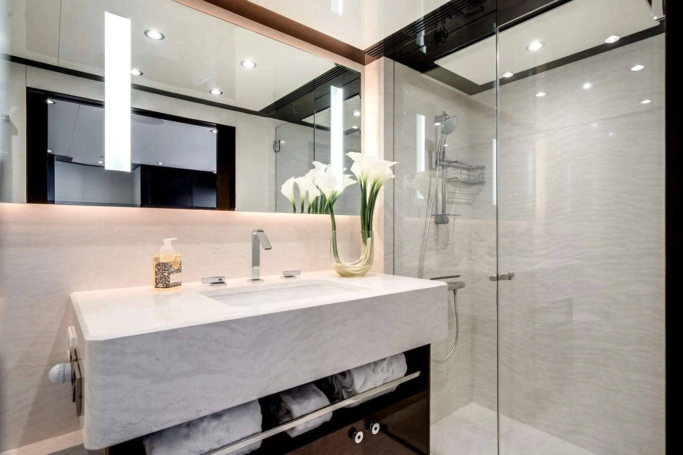 A luxurious yacht bathroom featuring a modern sink, elegant lighting, and a spacious shower area. aboard OCEAN ALEXANDER 37L/01 Yacht for Sale
