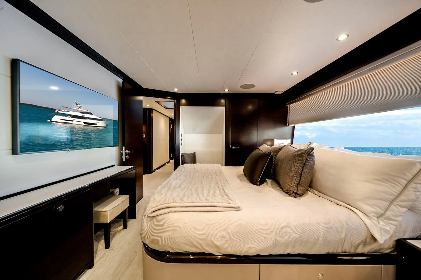 The luxurious stateroom features a plush bed, modern decor, and a large window offering stunning ocean views. aboard OCEAN ALEXANDER 37L/01 Yacht for Sale