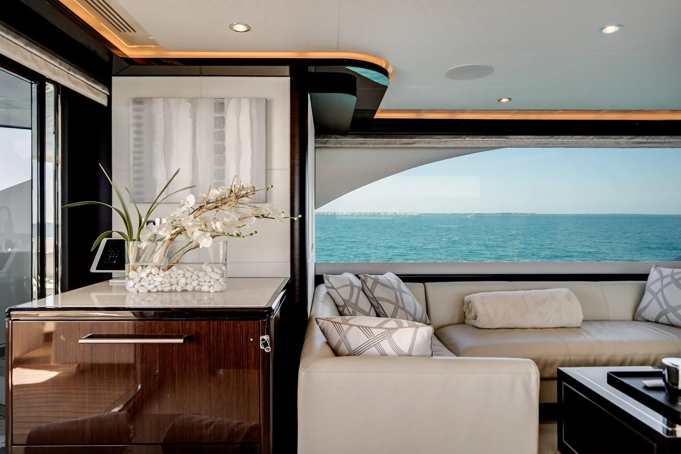 The yacht's interior features a stylish seating area with large windows offering stunning ocean views. aboard OCEAN ALEXANDER 37L/01 Yacht for Sale