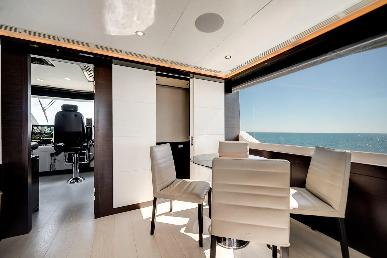 The yacht's dining area offers a serene space with panoramic ocean views and modern furnishings. aboard OCEAN ALEXANDER 37L/01 Yacht for Sale