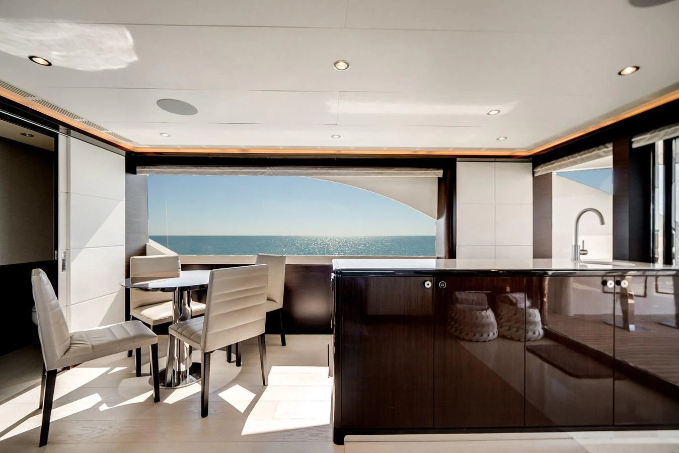 The yacht's salon features a modern dining area with panoramic ocean views. aboard OCEAN ALEXANDER 37L/01 Yacht for Sale