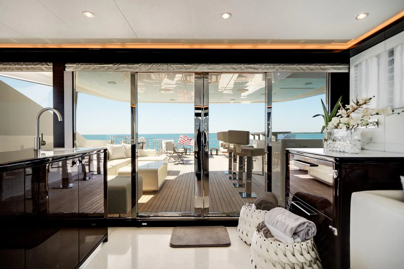 This luxurious yacht interior opens up to a spacious deck with stunning ocean views. aboard OCEAN ALEXANDER 37L/01 Yacht for Sale