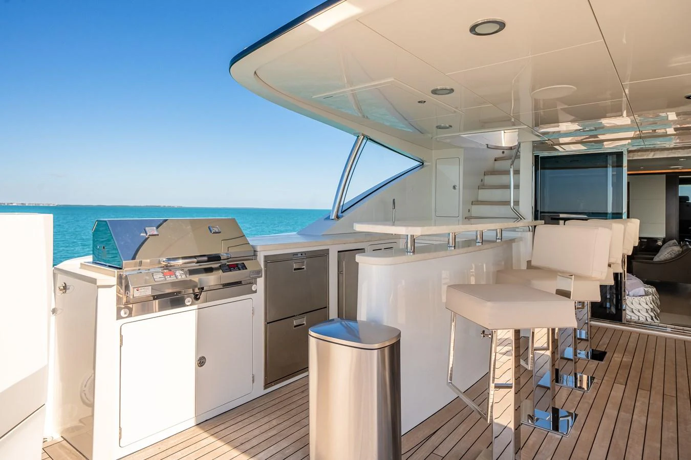 The flybridge features a sleek outdoor kitchen and bar area with stunning ocean views. aboard OCEAN ALEXANDER 37L/01 Yacht for Sale