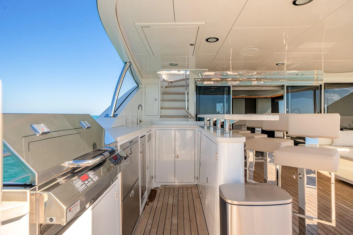 The flybridge features a sleek outdoor kitchen and bar area with comfortable seating. aboard OCEAN ALEXANDER 37L/01 Yacht for Sale