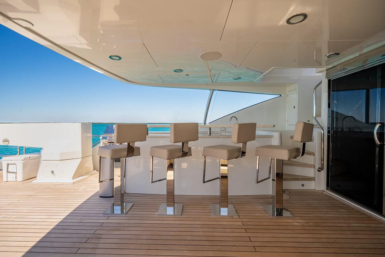 The yacht features a stylish bar area with modern seating and a view of the ocean. aboard OCEAN ALEXANDER 37L/01 Yacht for Sale