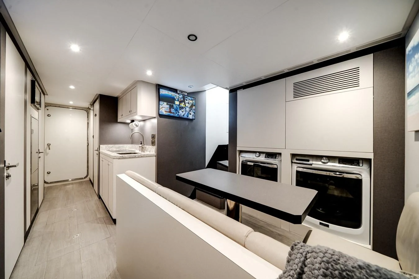 The modern galley features sleek appliances and a cozy dining area. aboard OCEAN ALEXANDER 37L/01 Yacht for Sale
