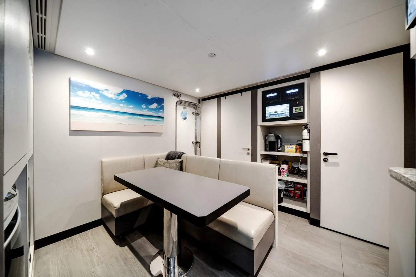 The yacht's interior dining area features a sleek table with comfortable seating and modern amenities. aboard OCEAN ALEXANDER 37L/01 Yacht for Sale