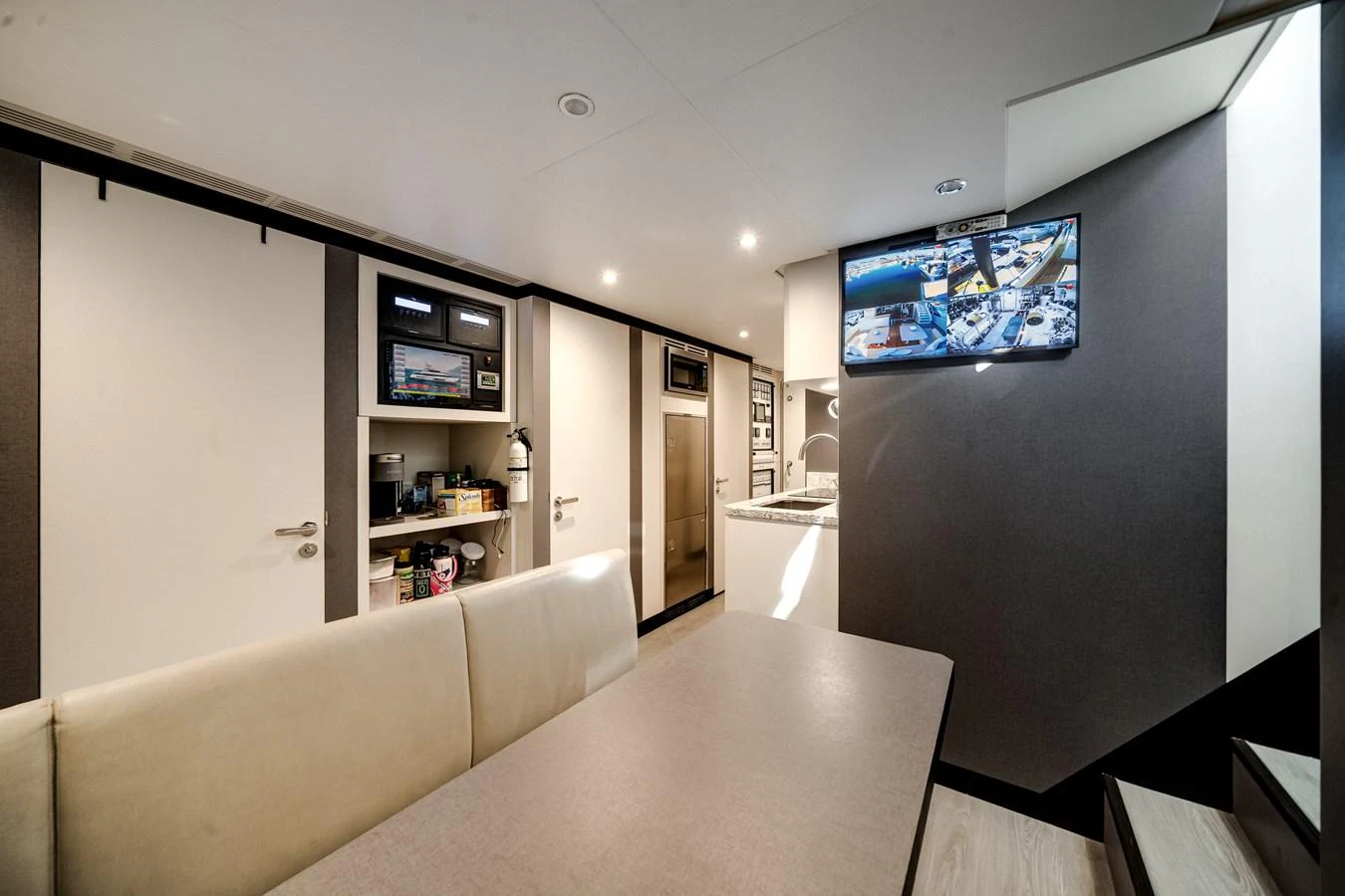 The crew area features a functional space with modern amenities and a comfortable seating area. aboard OCEAN ALEXANDER 37L/01 Yacht for Sale