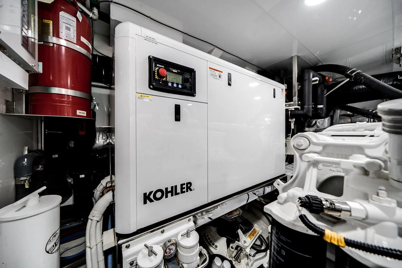 The engine room features a Kohler generator and various mechanical components, showcasing the yacht's technical infrastructure. aboard OCEAN ALEXANDER 37L/01 Yacht for Sale